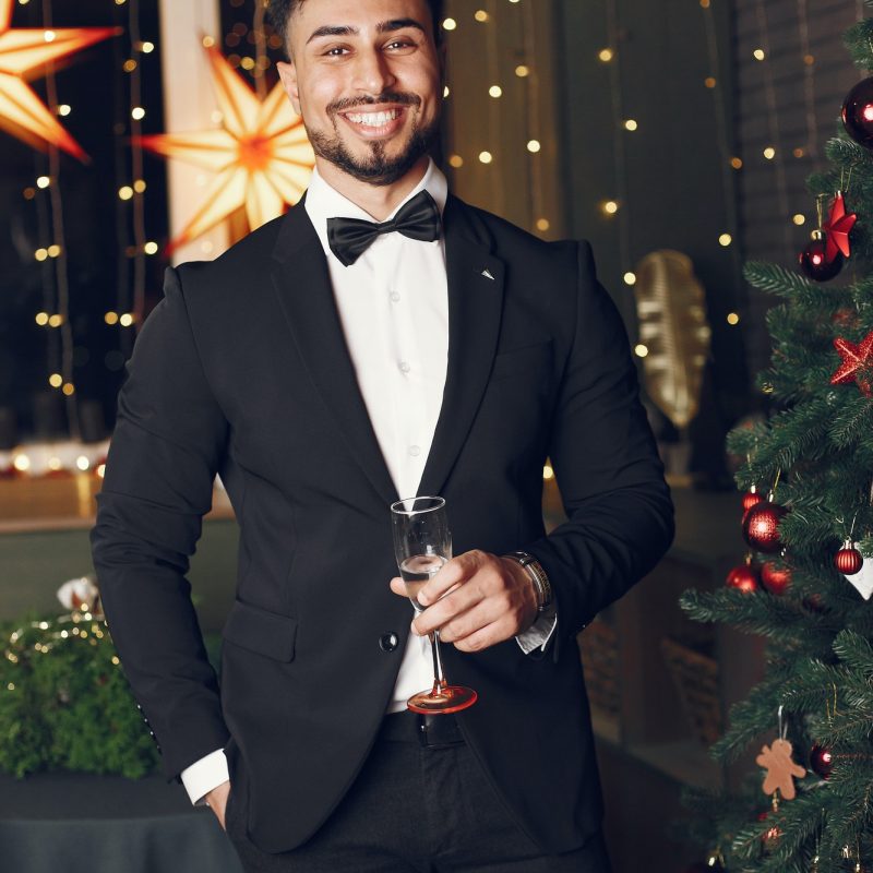 smiling man in a suit with Christmas decorations